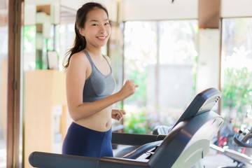 Fototapeta premium Portrait beautiful young asian woman exercise with fitness equipment in gym interior