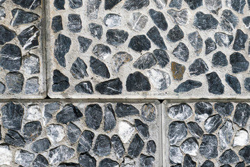 detail background of rock wall granite texture background with tile and grout joints