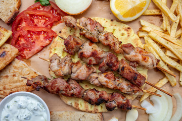 Souvlaki, meat skewers, traditional greek turkish meat food on pita bread, tzatziki sauce and potatoes