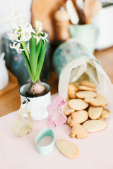 Fototapeta na wymiar Baked easter cookies in metal container on wooden table in the kitchen