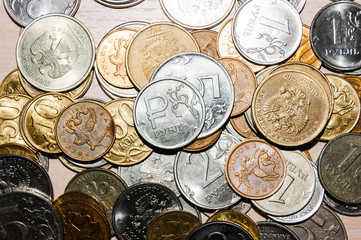 Russian coins of different denominations, the ruble sign is on the table