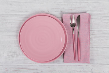 Pink rustic table setting with linen napkin on white wooden table