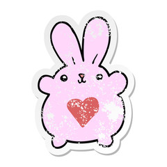 distressed sticker of a cute cartoon rabbit with love heart