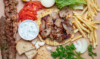 Traditional turkish, greek meat food. Shawarma, gyros, kebab, souvlaki and tzatziki on pita bread
