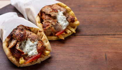 Gyro pita, shawarma, take away, street food. Traditional greek turkish, meat food on wooden table