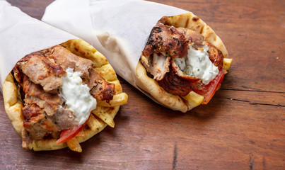 Gyro pita, shawarma, take away, street food. Traditional greek turkish, meat food on wooden table