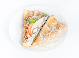 Thin delicious pancake with four types of cheese on white