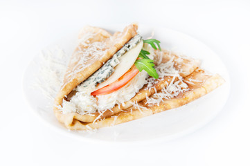 Thin delicious pancake with four types of cheese on white