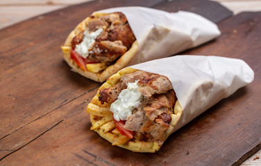 Gyro pita, shawarma, take away, street food. Traditional greek turkish, meat food on wooden table