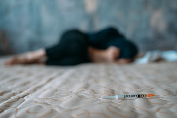 Female junkie sleeping in bed after dose