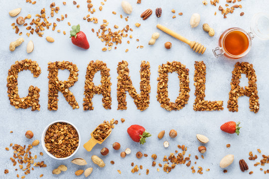 Word granola made of baked oats granola. Background.