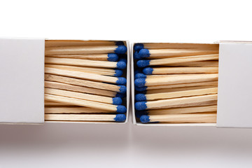 matchbox with blue matchsticks on white with clipping path