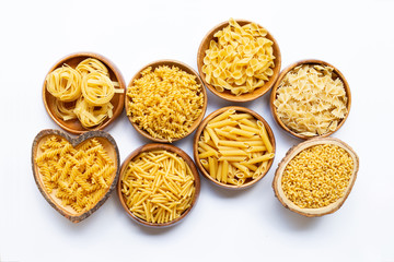 Different types of dry pasta on white.