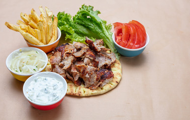 Shawarma, gyros on pita bread, vegetables and tzatziki sauce. Traditional turkish, greek meat food.