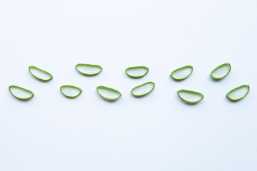 Aloe vera slices on white background.
