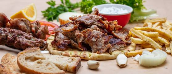 Gyros pita, Shawarma. Traditional greek, turkish meat food on pita bread and tzatziki, banner