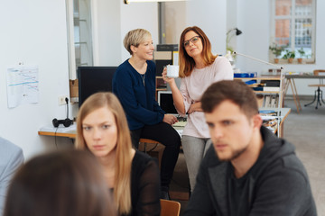 Two women having conversation in office