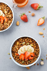 Homemade oats and nuts granola with strawberry, banana and honey