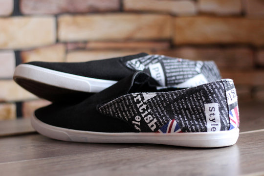 Fashionable black sneakers with English pattern and text