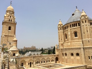 Obraz premium The bell tower and lead-covered cupola of the Abbey of the Dormition, an abbey and the name of a Benedictine community in Jerusalem on Mount Zion just outside the the Old City near the Zion Gate. 