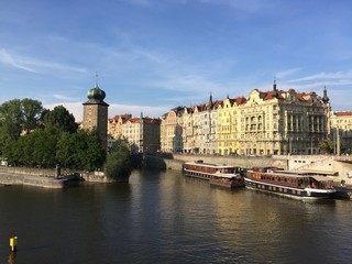 Fototapeta na wymiar The Šítkov water tower and the banks of the Vltava River seen from Jirásek Bridge in Prague, Czech Republic