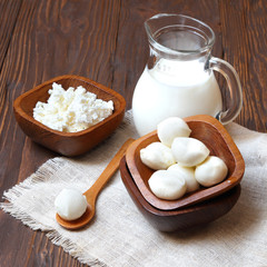 Mozzarella cheese in a wooden bowl on the  table