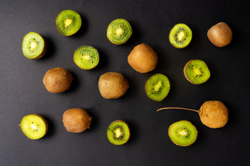 Kiwi on black background top view
