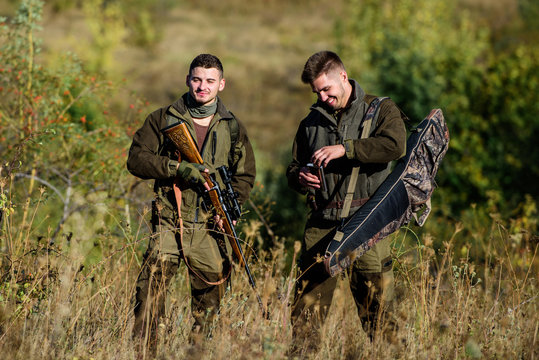 Friendship of men hunters. Man hunters with rifle gun. Boot camp. Military uniform fashion. Army forces. Camouflage. Hunting skills and weapon equipment. Hunters gamekeepers relaxing