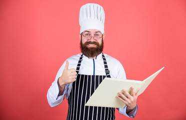 Improve cooking skill. Book recipes. According to recipe. Man bearded chef cooking food. Culinary arts concept. Amateur cook read book recipes. Man learn recipe. Try something new. Cookery on my mind