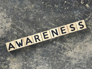 Motivational and inspirational word - AWARENESS written on wooden blocks.