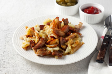 Crispy pan fried potatoes with pork, pickles and tomato ketchup sauce