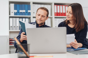 Businessman and woman working on paperwork