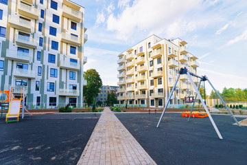 Fototapeta na wymiar New residential apartment flat house building and child playground