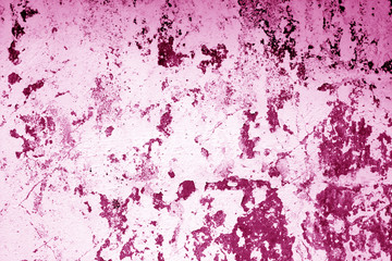 Сraked weathered cement wall texture in pink tone.