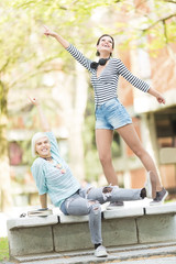 Young beautiful students(one with flower tights) outdoors in campus