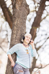 Young beautiful student with flower tights listening to a music