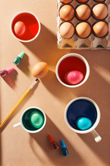 A dozen eggs in a carton, used watercolor paints.