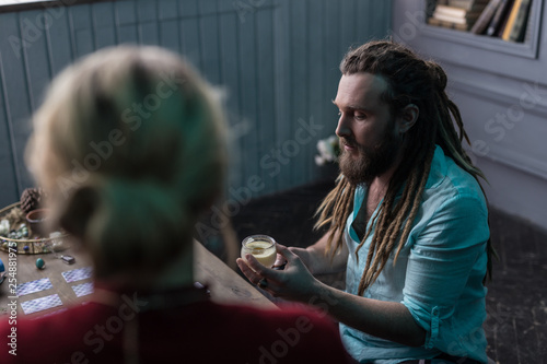 Nice bearded man focusing on his work