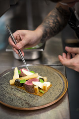 chef completing fine dining dish