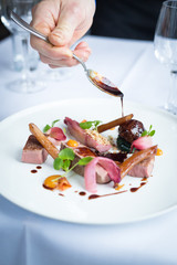 pink duck dish on white plate