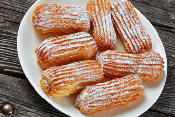 Homemade sweet Eclairs on a white plate