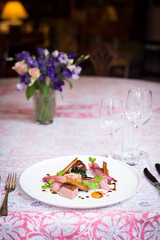 duck dish on pink patterned tablecloth