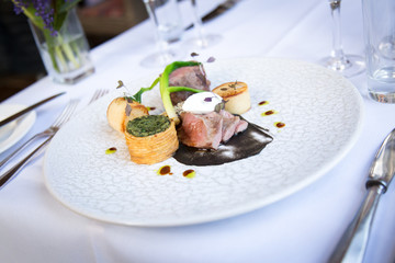 Delicate beef dish on table setting 