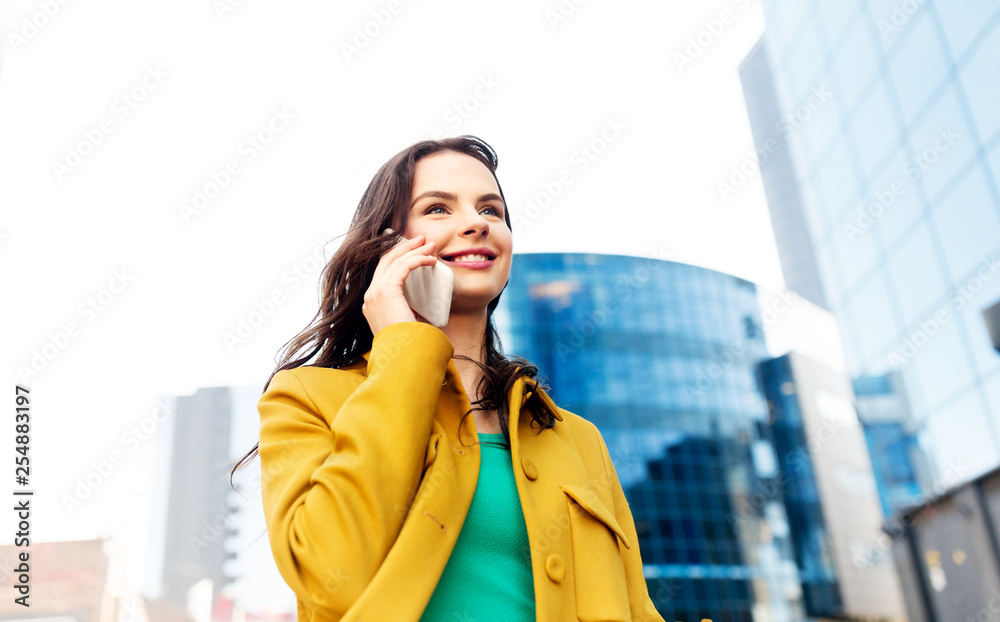 Poster technology, communication and people concept - smiling young woman or girl calling on smartphone on city street