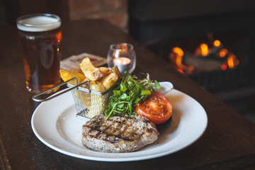 Grilled steak with chunky chips and salad
