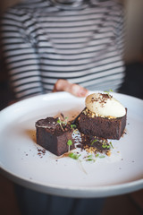 Serving chocolate cake with ice cream