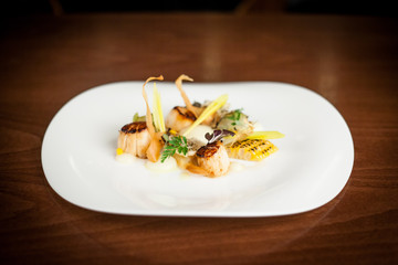delicate swan scallops on white plate