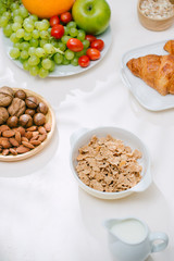 Obraz na płótnie Canvas Light healthy Breakfast with oatmeal. Hercules, nuts, fruit, boiled eggs, bread. Tableware. Healthy food.
