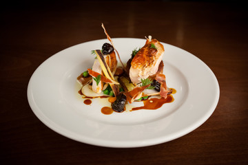 Roast chicken beautifully presented on white plate