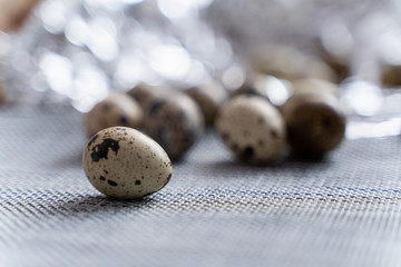 quail eggs on grey fabric table and beautiful blurred background